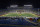 A small number of athletes' invited guests from Michigan and Wisconsin watch in an otherwise empty Michigan Stadium at the kickoff of an NCAA college football game in Ann Arbor, Mich., Saturday, Nov. 14, 2020. (AP Photo/Tony Ding)