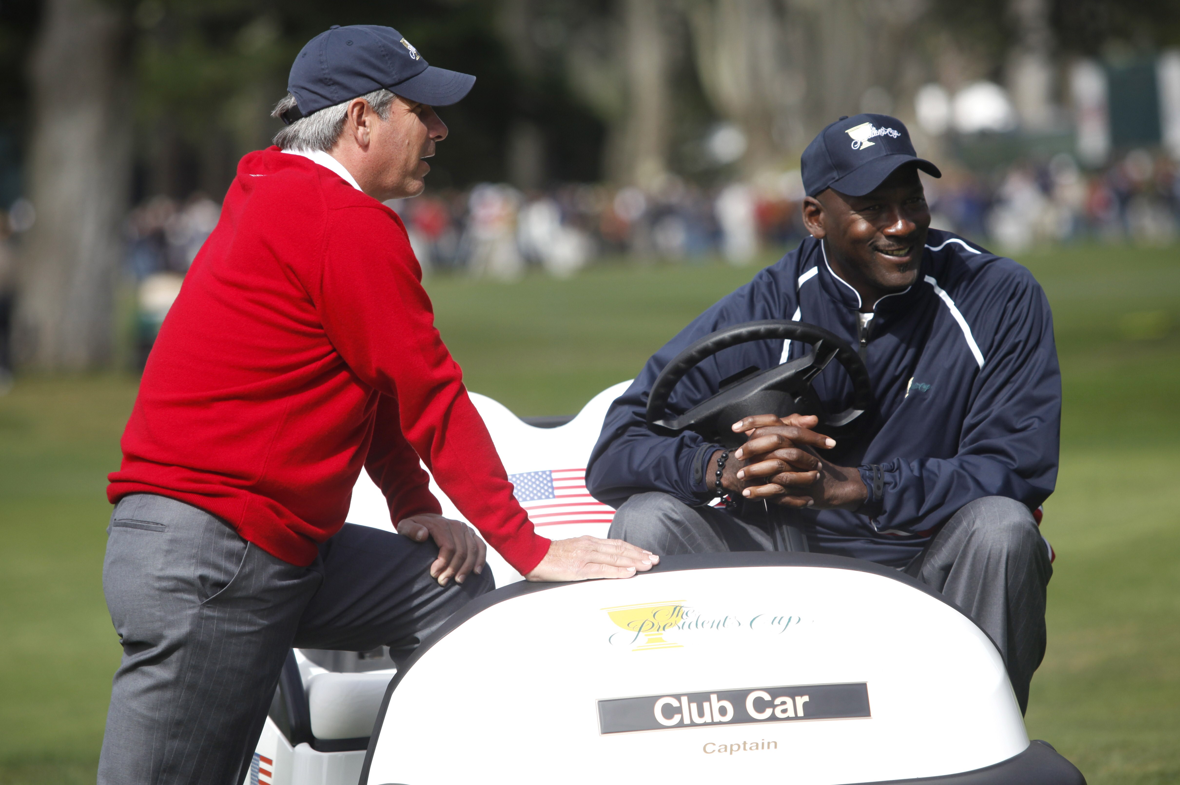 United States captain Fred Couples, left, talks with team captain's assistant Michael Jordan on the eighth fairway at golf's Presidents Cup at Harding Park Golf Course Thursday, Oct. 8, 2009. (AP Photo/Jeff Chiu)