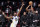 Golden State Warriors center James Wiseman (33) defends as Brooklyn Nets forward Kevin Durant (7) looks to shoot during the first quarter of an opening night NBA basketball game, Tuesday, Dec. 22, 2020, in New York. (AP Photo/Kathy Willens)