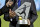 NWSL commissioner Jeff Plush presents FC Kansas City with the trophy after the NWSL soccer championship match in Portland, Ore., Thursday, Oct. 1, 2015. FC Kansas City won the match 1-0. (AP Photo/Craig Mitchelldyer)