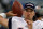 FILE - In this Aug. 4, 2000, file photo, New England Patriots backup quarterback Tom Brady warms up on the sidelines before an NFL football game against the Detroit Lions at the Silverdome in Pontiac, Mich. Brady grew from a sixth-round draft choice into one of the best quarterbacks in NFL history. On Tuesday, NFL commissioner Roger Goodell hears Brady's appeal of a four-game suspension for using deflated footballs in the AFC championship game. How will that affect Brady's legacy?  (AP Photo/Carlos Osorio, File)