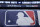 Rain drops cover a baseball logo before Game 1 of the Major League Baseball World Series between the New York Mets and Kansas City Royals, Tuesday, Oct. 27, 2015, in Kansas City, Mo. (AP Photo/Matt Slocum)