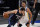 Dallas Mavericks' Luka Doncic (77) works against Golden State Warriors' Stephen Curry, right, in the second half of an NBA basketball game in Dallas, Saturday, Feb. 6, 2021.  (AP Photo/Tony Gutierrez)