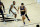 Phoenix Suns guard Devin Booker (1) drives as Milwaukee Bucks forward Khris Middleton defends during the first half of an NBA basketball game Wednesday, Feb. 10, 2021, in Phoenix. (AP Photo/Matt York)