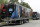 Equipment trailers are lined up at the entrance road to the WWE Performance Center Tuesday, April 14, 2020, in Orlando, Fla.  Florida’s top emergency official last week amended Gov. Ron DeSantis’ stay-at-home order to include employees at the professional sports and media production with a national audience, if the location is closed to the public. (AP Photo/John Raoux)