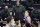 File-Baylor head coach Scott Drew, top center, reacts to a play in the second half of an NCAA college basketball game against Kansas, Monday, Jan. 18, 2021, in Waco, Texas. “You get to spend the entire year helping your game get better without the outside pressure or having to worry about being ready for each and every game, so it’s truly one year of development,” Drew said of redshirts, for current players and Bears in the past decade who went on to play professionally. (AP Photo/Jerry Larson, File)