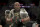 Daniel Cormier holds his belts after defeating Derrick Lewis by submission during the second round of a heavyweight mixed martial arts bout at UFC 230, early Sunday, Nov. 4, 2018, at Madison Square Garden in New York. (AP Photo/Julio Cortez)