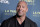 FILE - In this April 5, 2018 file photo, Dwayne Johnson attends the 2018 LA Family Housing Awards in West Hollywood, Calif. Johnson announced the birth of his third daughter Monday, April 23, on Instagram. He showed off a chest full of tattoos in a hospital snap with his latest addition, Tiana Gia Johnson. It’s his second daughter with partner Lauren Hashian. He also has a 16-year-old daughter with his former wife, Dany Garcia. He said Hashian labored like a “rock star.” (Photo by Richard Shotwell/Invision/AP, File)