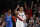 Portland Trail Blazers guard Damian Lillard, right, reacts after making a basket as Oklahoma City Thunder forward Paul George, left, trails the play during the first half of Game 1 of a first-round NBA basketball playoff series in Portland, Ore., Sunday, April 14, 2019. (AP Photo/Steve Dipaola)