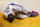 Los Angeles Lakers forward LeBron James holds his ankle after going down with an injury during the first half of an NBA basketball game against the Atlanta Hawks Saturday, March 20, 2021, in Los Angeles. (AP Photo/Marcio Jose Sanchez)