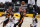 CORRECTS TO SECOND HALF, NOT FIRST HALF - Atlanta Hawks guard Trae Young, center, shoots over Los Angeles Lakers forward Markieff Morris, left, and Dennis Schroder, left, during the second half of an NBA basketball game Saturday, March 20, 2021, in Los Angeles. (AP Photo/Marcio Jose Sanchez)