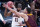 Illinois' Ayo Dosunmu (11) is defended by Loyola of Chicago's Lucas Williamson (1) during the first half of a college basketball game in the second round of the NCAA tournament at Bankers Life Fieldhouse in Indianapolis Sunday, March 21, 2021. (AP Photo/Mark Humphrey)
