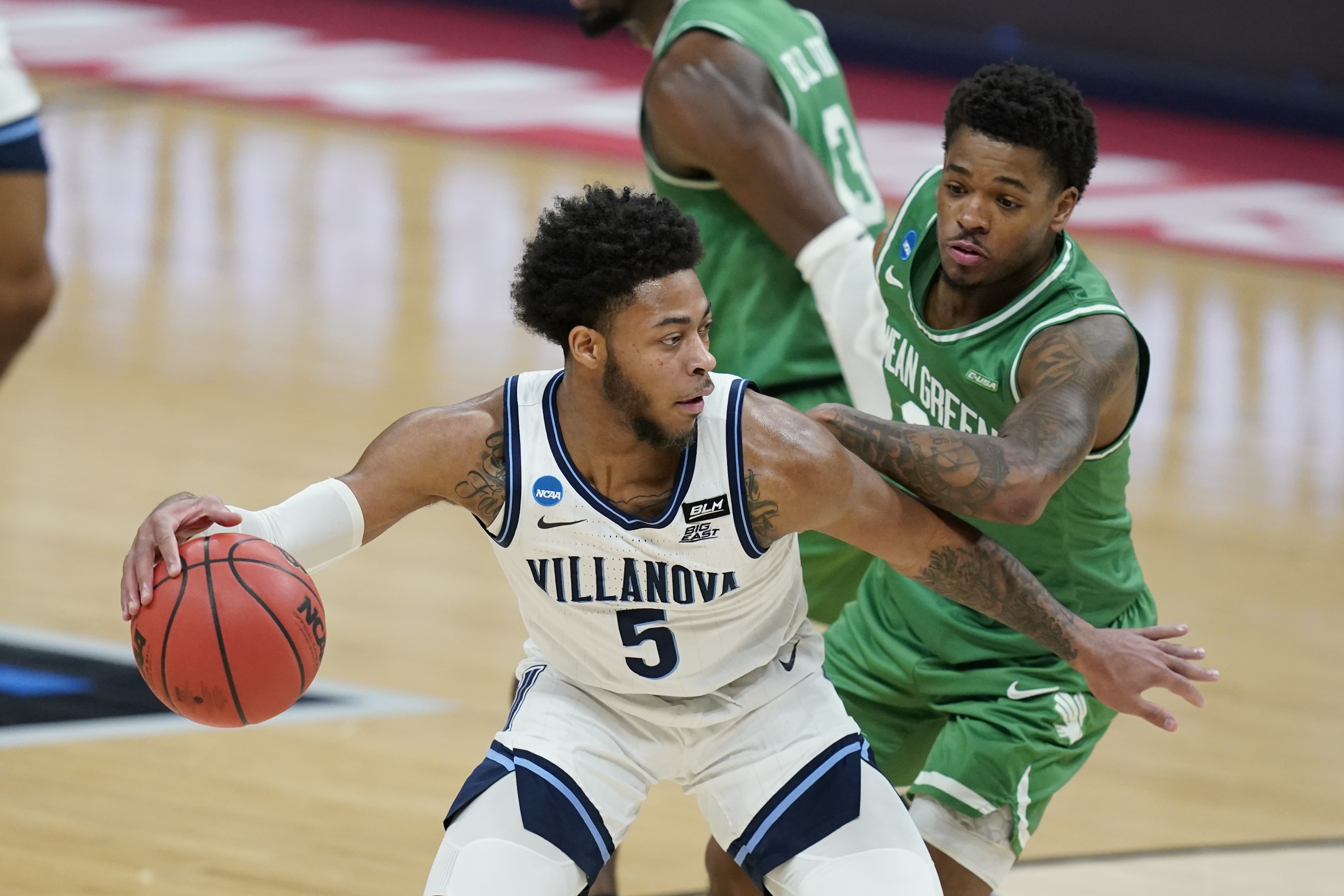 Villanova's Justin Moore (5) is defended by North Texas' Javion Hamlet (3) during the first half of a second-round game in the NCAA men's college basketball tournament at Bankers Life Fieldhouse, Sunday, March 21, 2021, in Indianapolis. (AP Photo/Darron Cummings)