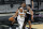 Denver Nuggets guard Gary Harris (14) drives around San Antonio Spurs center LaMarcus Aldridge (12) during the first half of an NBA basketball game in San Antonio, Friday, Jan. 29, 2021. (AP Photo/Eric Gay)