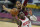 Houston Rockets' Victor Oladipo, front, drives to the basket against Cleveland Cavaliers' Isaac Okoro in the second half of an NBA basketball game, Wednesday, Feb. 24, 2021, in Cleveland. The Cavaliers won 112-96. (AP Photo/Tony Dejak)