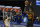 Atlanta Hawks forward John Collins (20) takes a 3-point shot past Golden State Warriors forward Draymond Green (23) during the second half of an NBA basketball game in San Francisco, Friday, March 26, 2021. (AP Photo/Tony Avelar)