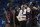 FILE - In this Feb. 14, 2019, file photo, Houston head coach Kelvin Sampson talks to his team during the first half of an NCAA college basketball game against Connecticut, in Hartford, Conn. The entire team piles into Sampson's house before each home game to prepare for the next opponent, eat his wife Karen's delicious homemade chocolate chip cookies and bond like a family. The routine is something Sampson and his players agree has created an environment of closeness and trust that is an integral ingredient in the ninth-ranked Cougars' success this season.(AP Photo/Jessica Hill, File)