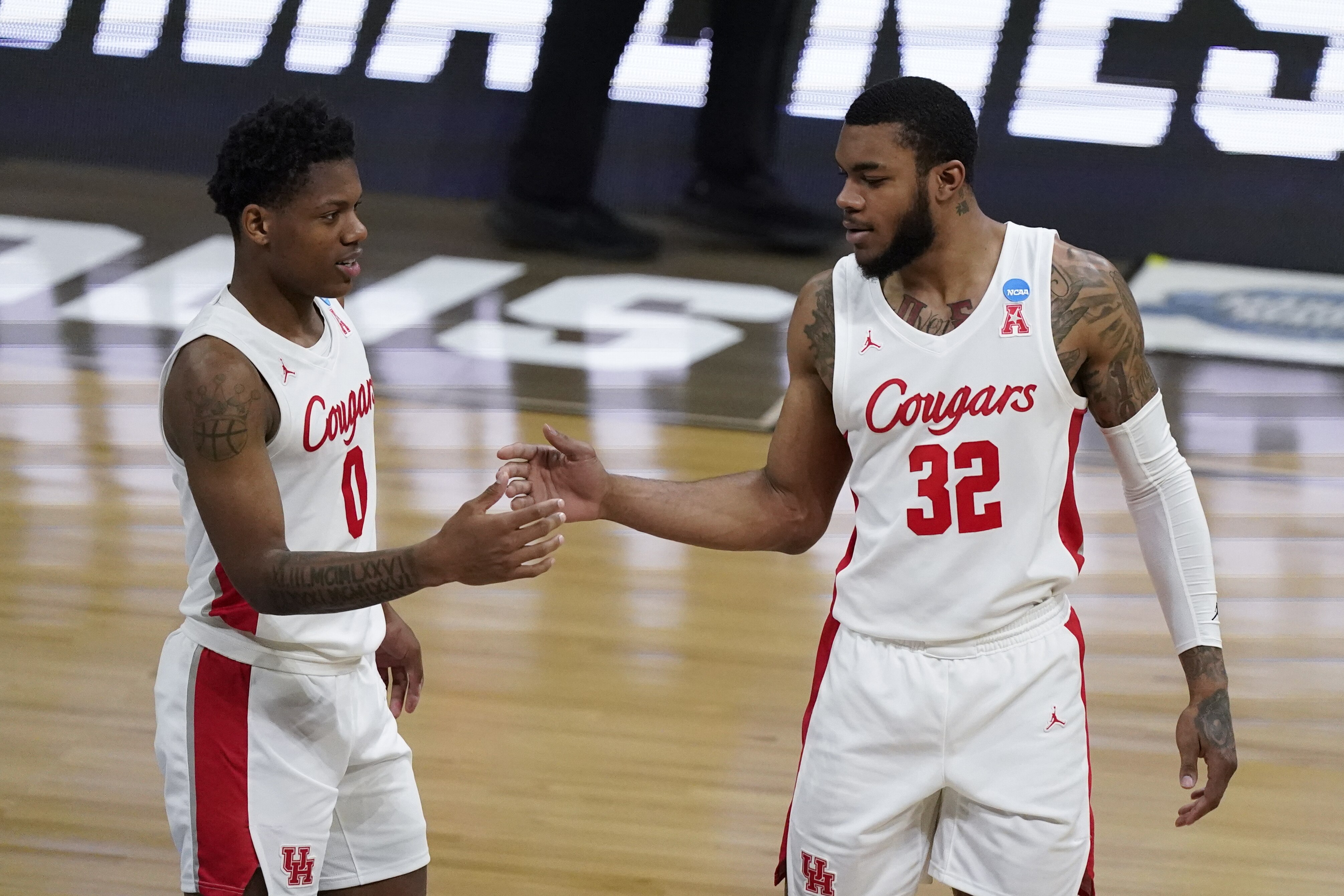 Houston guard Marcus Sasser (0) and Houston forward Reggie Chaney (32) react to a play against Oregon State during the second half of an Elite 8 game in the NCAA men's college basketball tournament at Lucas Oil Stadium, Monday, March 29, 2021, in Indianapolis. (AP Photo/Michael Conroy)