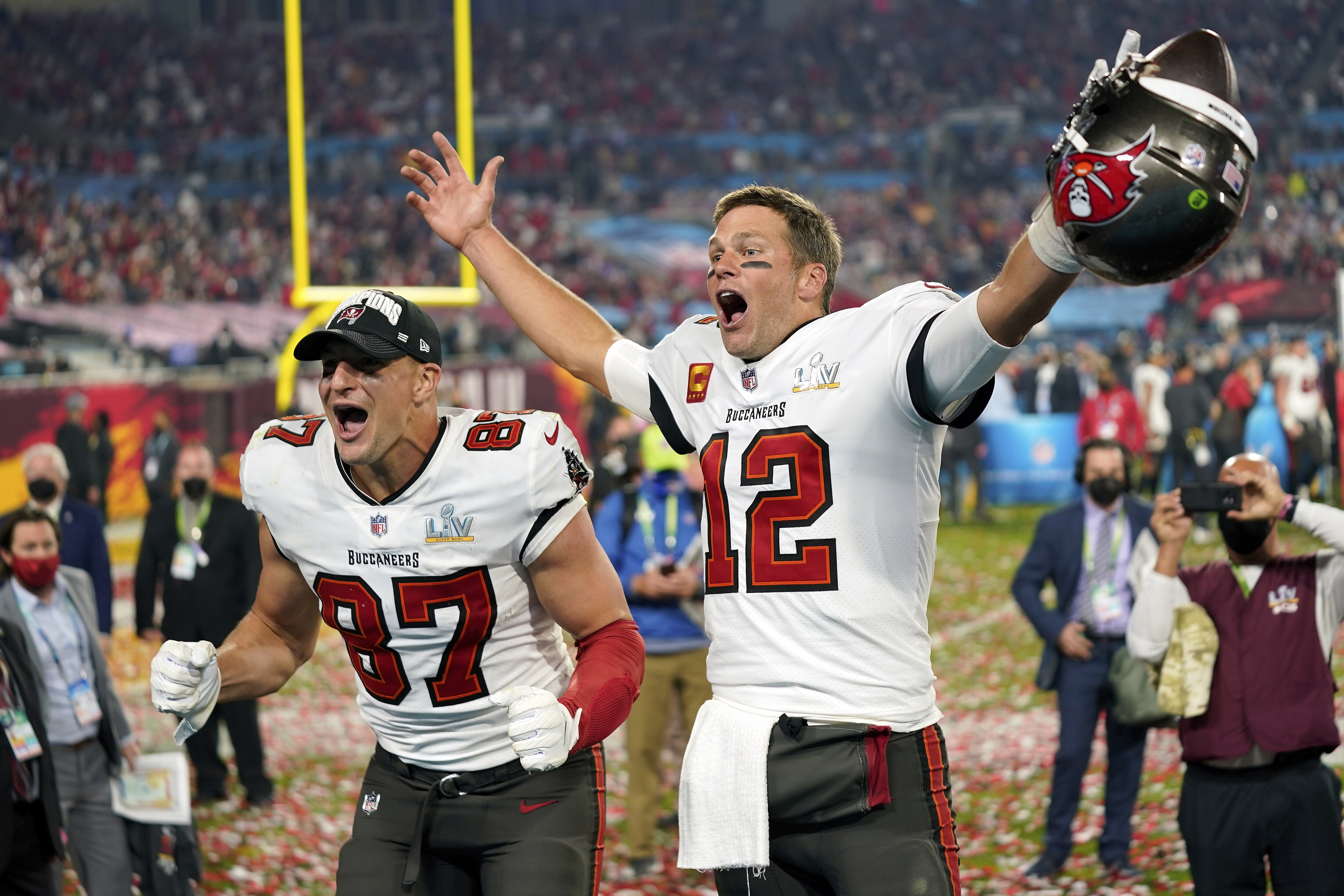 FILE - In this Sunday, Feb. 7, 2021 file photo, Tampa Bay Buccaneers tight end Rob Gronkowski (87), left, and Tampa Bay Buccaneers quarterback Tom Brady (12) celebrate together after the NFL Super Bowl 55 football game against the Kansas City Chiefs in Tampa, Fla. NFL Films has been chronicling Tom Brady’s career since he entered the league in 2000, but there are still times when there are still new things to reveal. That is the case with this year’s Super Bowl film, chronicling Brady’s seventh championship and his first with the Tampa Buccaneers. (AP Photo/Steve Luciano, File)