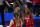Arizona guard Aari McDonald (2) celebrates with teammate guard Helena Pueyo (13) in front of Connecticut forward Aaliyah Edwards after getting fouled during the second half of a women's Final Four NCAA college basketball tournament semifinal game Friday, April 2, 2021, at the Alamodome in San Antonio. (AP Photo/Eric Gay)