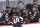St. Cloud State's Nolan Walker (20) is greeted by teammates after scoring against Minnesota State to break a tie with less than a minute left in an NCAA men's Frozen Four hockey semifinal in Pittsburgh, Thursday, April 8, 2021. St. Cloud State won 5-4 to advance to the championship game Saturday. (AP Photo/Keith Srakocic)