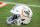 A Miami Dolphins football helmet sits on the field as the Dolphins take on the Kansas City Chiefs during an NFL football game, Sunday, Dec. 13, 2020, in Miami Gardens, Fla. (AP Photo/Doug Murray)