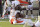 Virginia Tech quarterback Hendon Hooker, center, is tackled by Miami defenders, Sam Brooks, Jr., right, and Jaelan Phillips, left, during the second half of an NCAA college football game Saturday, Nov. 14, 2020, in Blacksburg, Va. (Matt Gentry/The Roanoke Times via AP, Pool)