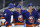 New York Islanders' Andy Greene (4) celebrates with teammates Noah Dobson (8) and Mathew Barzal (13) after scoring against the New York Rangers during the second period of an NHL hockey game Friday, April 9, 2021, in Uniondale, N.Y. (AP Photo/Jason DeCrow)