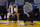 Golden State Warriors guard Stephen Curry, left, sits on the sideline next to assistant coach Bruce Fraser during the second half of the team's NBA basketball game against the Dallas Mavericks in San Francisco, Tuesday, April 27, 2021. (AP Photo/Jeff Chiu)