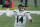 FILE - In this Jan. 3, 2021, file photo, New York Jets quarterback Sam Darnold rolls out to pass against the New England Patriots during the first half of an NFL football game in Foxborough, Mass. The Jets will get back on the rookie quarterback roller coaster three years after trading up to take Darnold with the third pick. With New York holding the second selection in a quarterback-heavy draft, general manager Joe Douglas dealt Darnold to Carolina and now has his eyes on another potential franchise QB. (AP Photo/Charles Krupa, File)