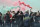 Manchester United fans protest outside the Lowry Hotel where team was staying during a protest against the Glazer family, owners of Manchester United, before their Premier League match against Liverpool at Old Trafford, Manchester, England, Sunday, May 2, 2021. Manchester United supporters stormed into the stadium and onto the pitch ahead of Sunday's game against Liverpool as fans gathered outside Old Trafford to protest against the ownership. The match later called-off. (AP Photo/Rui Vieira)