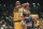 Los Angeles Laker guard Kobe Bryant (8) passes to a teammate under the basket as Houston Rockets, Sam Mack looks on during the first half at the Forum in Inglewood, California on Friday, March 7, 1997. (AP Photo/E. J. Flynn)