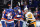 New York Islanders' Brock Nelson celebrates with teammates after scoring a goal as Pittsburgh Penguins' Sidney Crosby (87) skates past them during the second period of Game 6 of an NHL hockey Stanley Cup first-round playoff series, Wednesday, May 26, 2021, in Uniondale, N.Y. (AP Photo/Frank Franklin II)