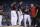 Washington Nationals starting pitcher Max Scherzer, center, stands on the mound as a trainer comes to check on him during the first inning of the team's baseball game against the San Francisco Giants, Friday, June 11, 2021, in Washington. Scherzer left the game with an injury. Nationals shortstop Trea Turner is at center left. (AP Photo/Nick Wass)