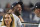 Retired New York Yankees pitcher CC Sabathia and his wife Amber walk through the stands during a baseball game between the New York Yankees and the Boston Red Sox, Sunday, June 6, 2021, at Yankee Stadium in New York. (AP Photo/Kathy Willens)