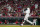 Cincinnati Reds' Nick Castellanos hits a solo home run during the fifth inning of the team's baseball game against the Pittsburgh Pirates in Cincinnati on Saturday, Aug. 7, 2021. (AP Photo/Jeff Dean)
