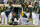 Oakland Athletics manager Bob Melvin, center right, and others attend to Elvis Andrus, center, after he collapsed with an injury after scoring a walk-off win against the Houston Astros in the ninth inning of a baseball game in Oakland, Calif., Saturday, Sept. 25, 2021. The Athletics won 2-1. (AP Photo/John Hefti)