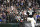Fans stand as they watch Chicago White Sox relief pitcher Liam Hendriks work during the ninth inning of a baseball game against the Detroit Tigers in Chicago, Saturday, Oct. 2, 2021. (AP Photo/Nam Y. Huh)