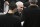 San Antonio Spurs head coach Gregg Popovich, center, talks to his players during a timeout in the first half of an NBA basketball game against the Los Angeles Clippers on Thursday, March 25, 2021, in San Antonio. (AP Photo/Darren Abate)