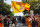 Tennessee's Davy Crockett mascot waves a flag during the Vol Walk before an NCAA college football game against Bowling Green Thursday, Sept. 2, 2021, in Knoxville, Tenn. (AP Photo/Wade Payne)