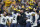 Michigan head coach Jim Harbaugh reacts with his players on the sideline during the second half of the Big Ten championship NCAA college football game against Iowa, Saturday, Dec. 4, 2021, in Indianapolis. (AP Photo/Darron Cummings)