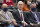 NBA Commissioner Adam Silver, center, looks on in the second half during an NBA basketball game between the Utah Jazz and the Oklahoma City Thunder on Wednesday, Oct. 20, 2021, in Salt Lake City. (AP Photo/Rick Bowmer)