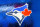 TORONTO, ONTARIO, CANADA - 2015/01/01: Logo of the Toronto Blue Jays baseball team on a blue frosted glass. The logo features the head of the 'Blue Jay' bird and the Canadian maple leaf in red. The Toronto Blue Jays are a Canadian professional baseball team based in Toronto, Ontario. The Blue Jays are a member of the East division of the American League in Major League Baseball. (Photo by Roberto Machado Noa/LightRocket via Getty Images)