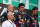 Mark Webber's reaction on the podium after Vettel (right) passed him against team orders.