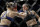 Amanda Nunes (right) punches Ronda Rousey.
