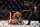 Referee Mario Yamasaki (right) stands over the action between Matthew Lopez (top) and Johnny Eduardo.