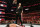 Baron Corbin standing over Seth Rollins.