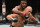 Ngannou (background) punches Dos Santos.