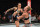 Amanda Nunes (left) kicks Holly Holm