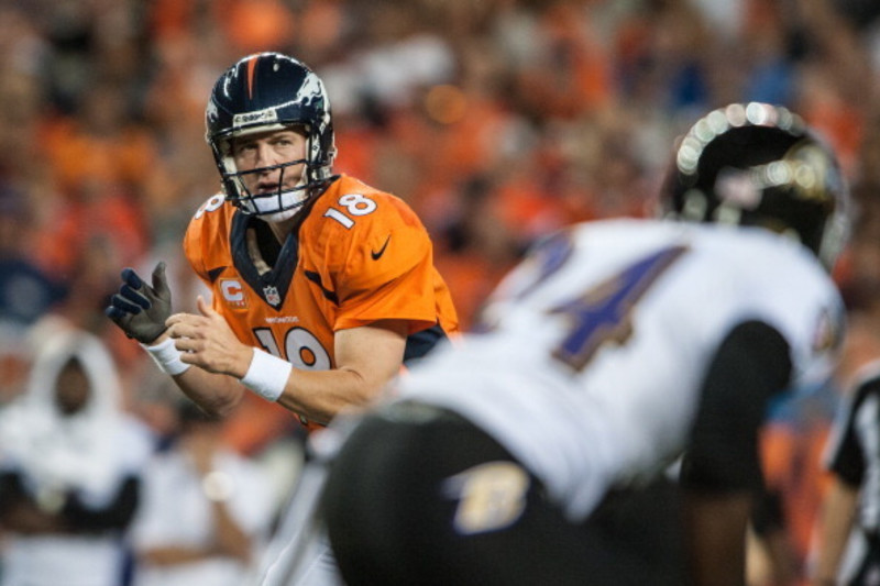 Denver Broncos quarterback Peyton Manning tries to put his jersey back on  his shoulder pads during an NFL football game between the Denver Broncos  and the Kansas City Chiefs, Sunday, Nov. 15